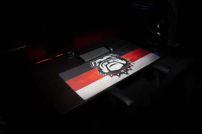 Wide view of the Georgia Bulldog's Pride deskmat in a dark gaming setup.