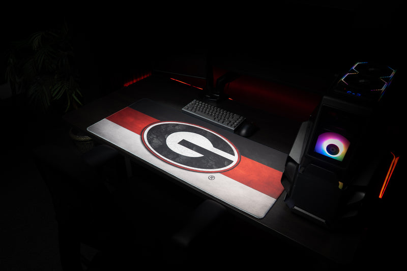 Angled workstation view of the University of Georgia Georgia Pride deskmat.