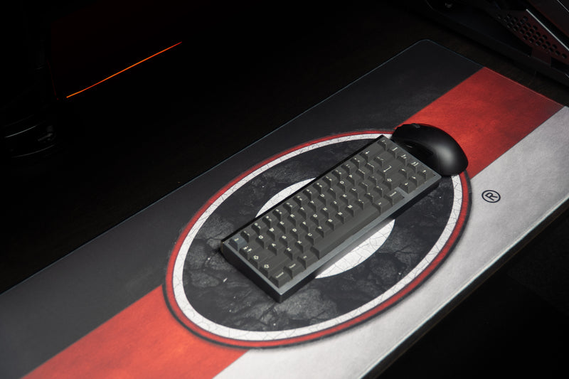 Keyboard and mouse on the University of Georgia Georgia Pride deskmat with red and silver stripes.