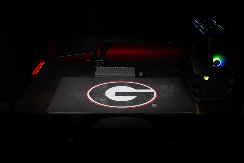Front view of the University of Georgia Grit deskmat on a gaming desk.