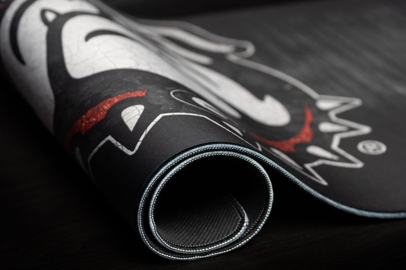 Rolled edge of the Georgia Mark of the Bulldog deskmat showing the mascot and stitched border.