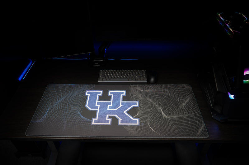 Front view of the University of Kentucky Afterglow deskmat beneath a keyboard in a gaming setup.