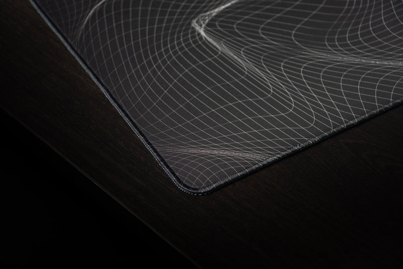 Close-up of the Kentucky Afterglow deskmat's stitched corner and flowing wireframe design.