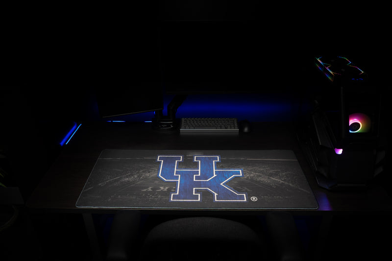 Front view of the Kentucky Home Turf deskmat with blue UK logo across a dark desk.