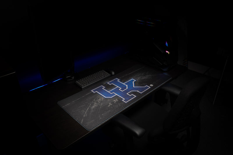 Wide gaming desk view featuring the Kentucky Home Turf deskmat and UK logo.