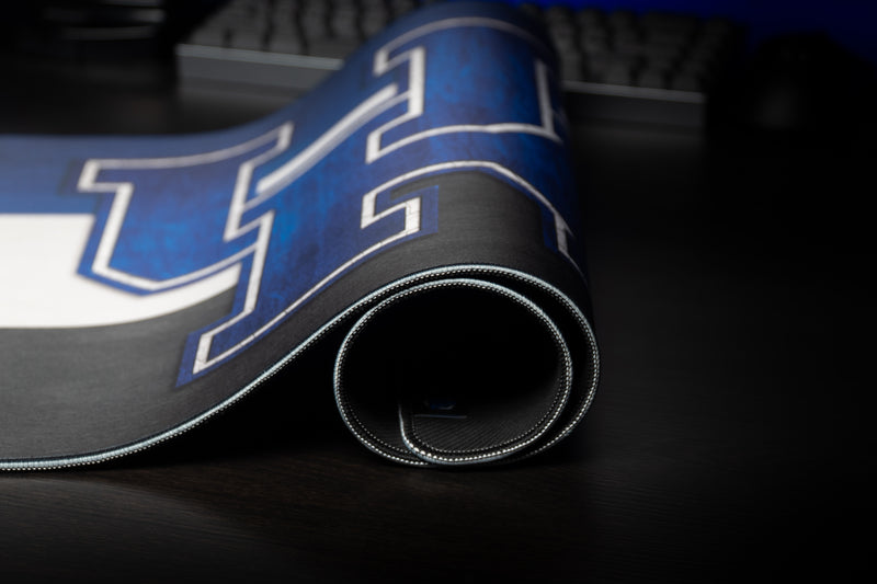 Rolled Kentucky Pride deskmat showing the blue UK logo and stitched border.