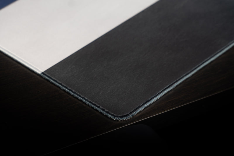 Close-up of the stitched corner of the Kentucky Pride deskmat where white and black stripes meet.