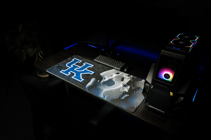 Kentucky Sound Wave deskmat across a gaming workstation with its blue UK logo and wildcat graphic.