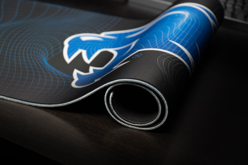 Rolled Kentucky Wildcat Afterglow deskmat showing the blue wildcat artwork and stitched edge.