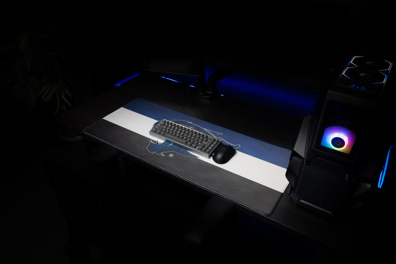 Keyboard and mouse resting on the Kentucky Wildcat Pride deskmat in a gaming setup.