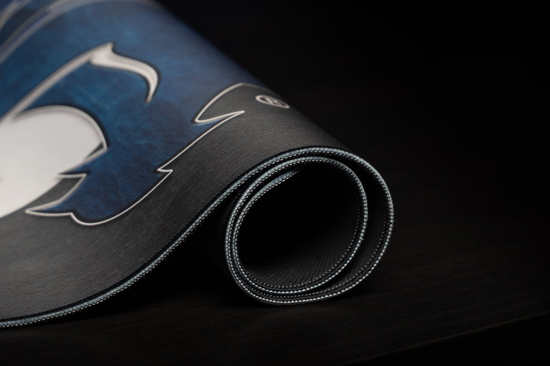 Rolled Kentucky Wildcat Pride deskmat showing the blue wildcat graphic and stitched edge.