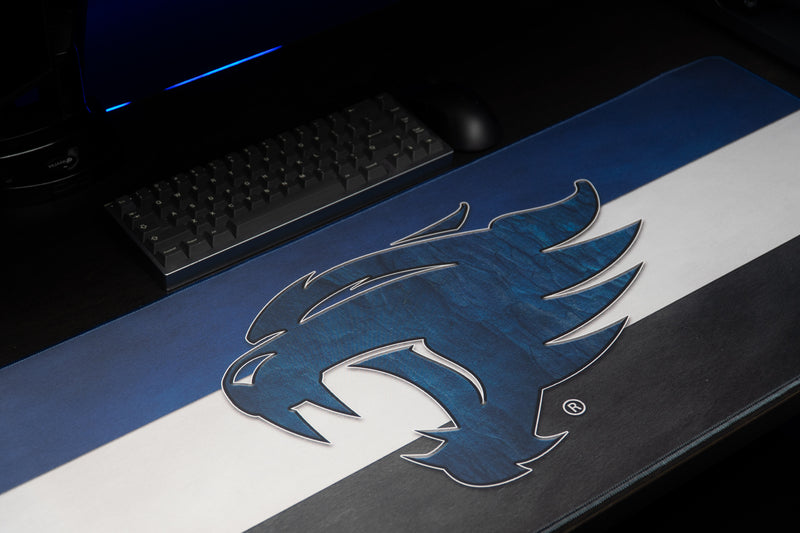 Close-up of the blue wildcat head on the Kentucky Wildcat Pride deskmat's striped design.