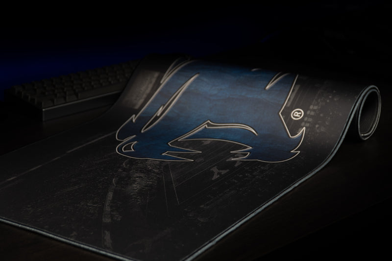 Close-up of the blue wildcat logo on the partly rolled Kentucky Home Turf deskmat.