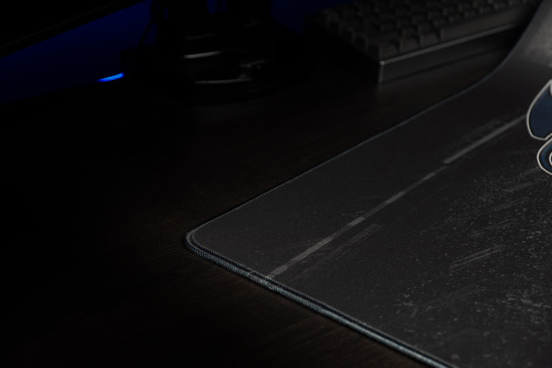 Close-up of the Kentucky Wild Cat's Home Turf deskmat's stitched corner and dark stadium design.