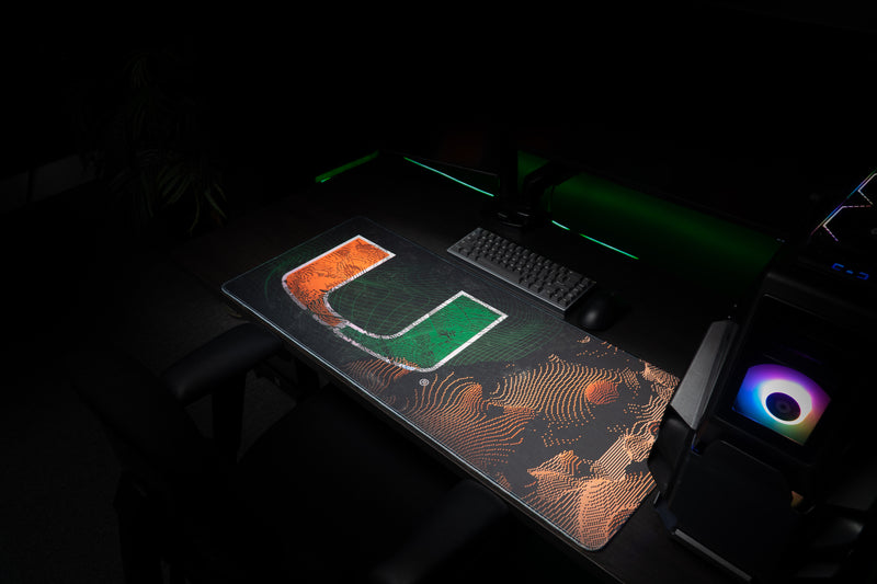 University of Miami Etched Storm deskmat angled view of the Etched Storm deskmat beside a gaming PC