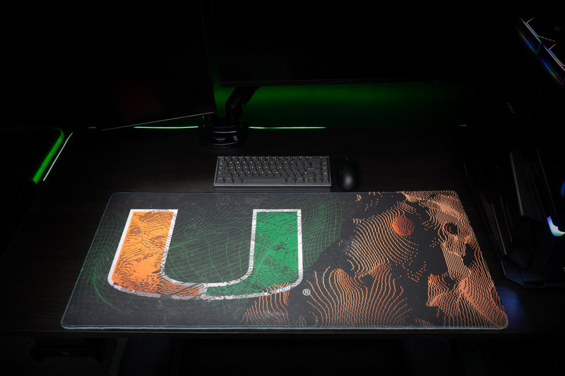 University of Miami Etched Storm deskmat front view of the U and orange etched contours on a gaming desk