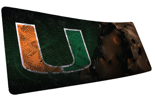 University of Miami Etched Storm deskmat mockup of the distressed orange-and-green U with etched lines on black