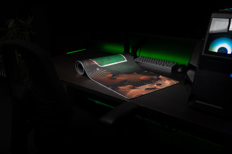 University of Miami Etched Storm deskmat partially rolled deskmat revealing orange etched contours