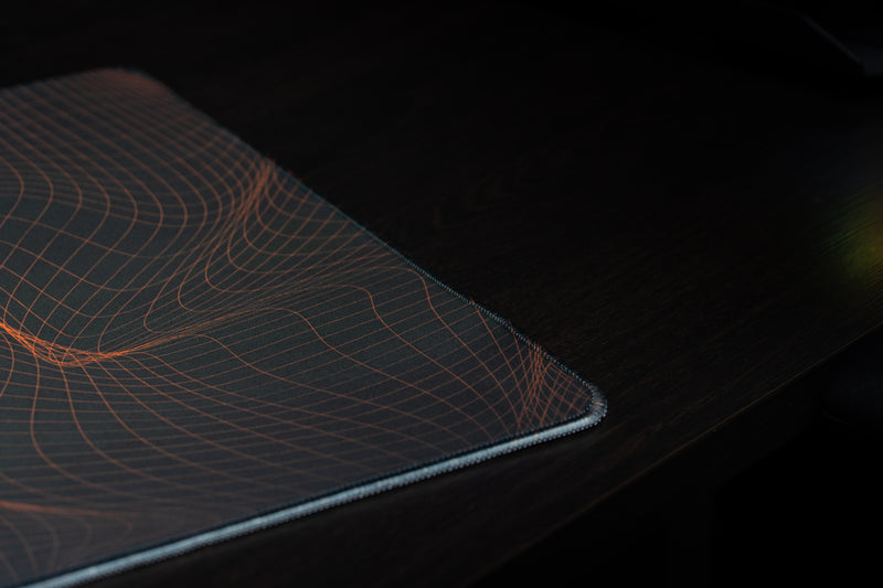 University of Miami Hurricane Flowstate deskmat close-up of orange wireframe lines at the stitched corner