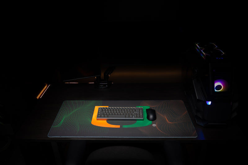 University of Miami Hurricane Flowstate deskmat front view with keyboard and mouse on the U deskmat