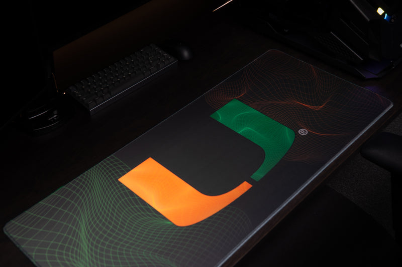 University of Miami Hurricane Flowstate deskmat high angled view showing the U and wireframe design