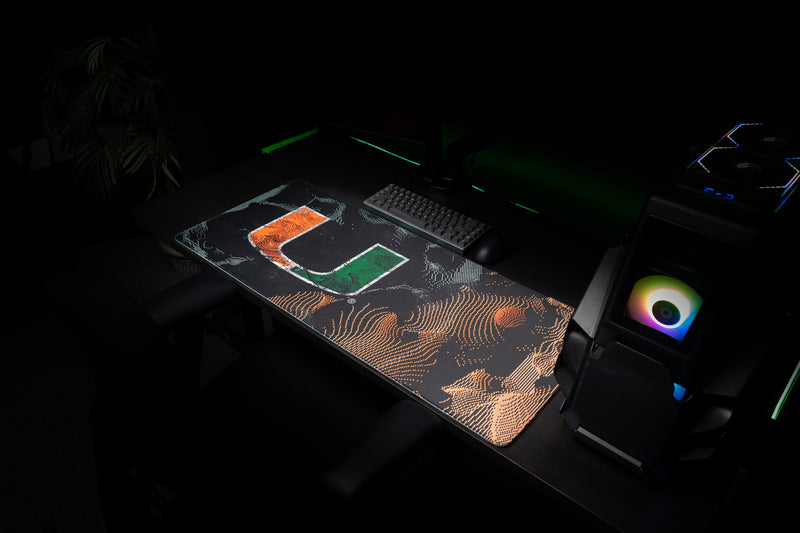 University of Miami Hurricane Static deskmat angled view of the Hurricane Static deskmat beside a gaming PC