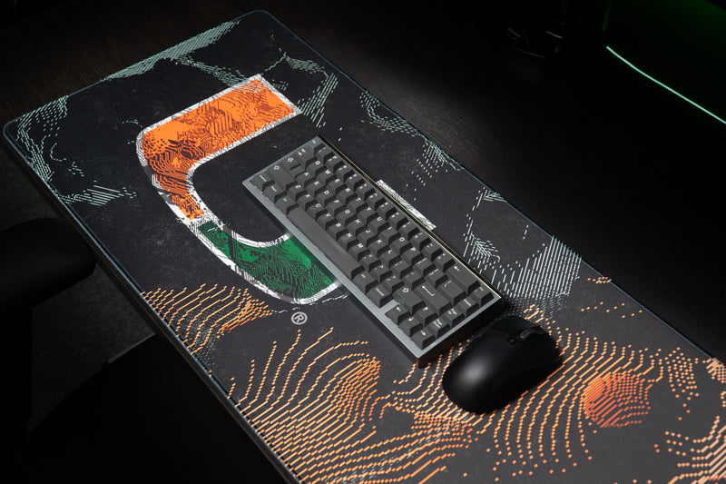 University of Miami Hurricane Static deskmat angled view with keyboard and mouse on the distressed U