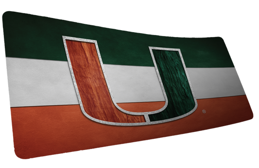 University of Miami Miami Pride deskmat mockup showing a bold orange-and-green U over green, white, and orange stripes