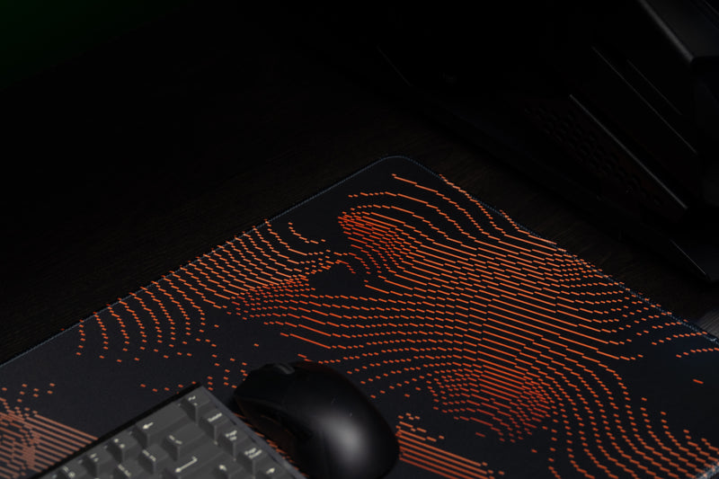 University of Miami Miami Surge deskmat close-up of orange current lines beside a mouse