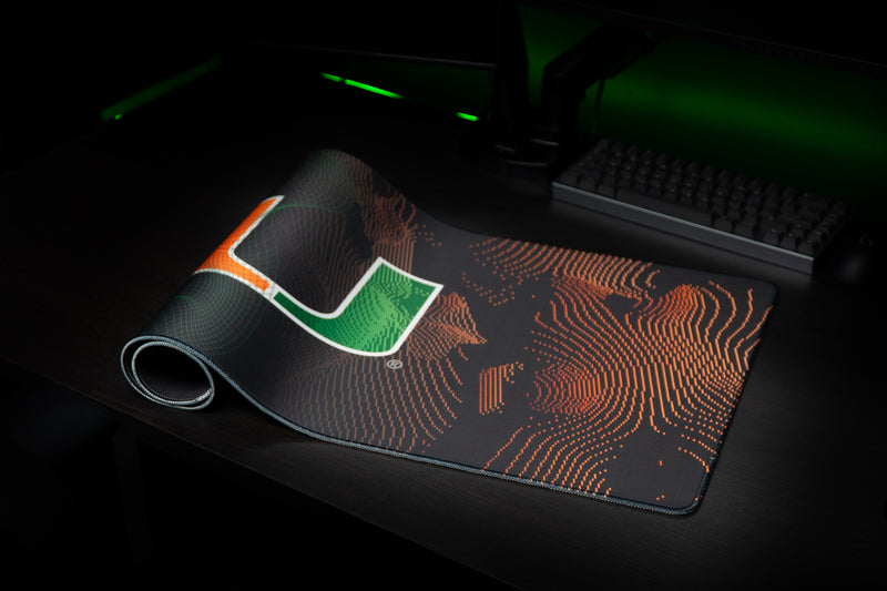 University of Miami Miami Surge deskmat partially rolled deskmat showing the U and orange current lines