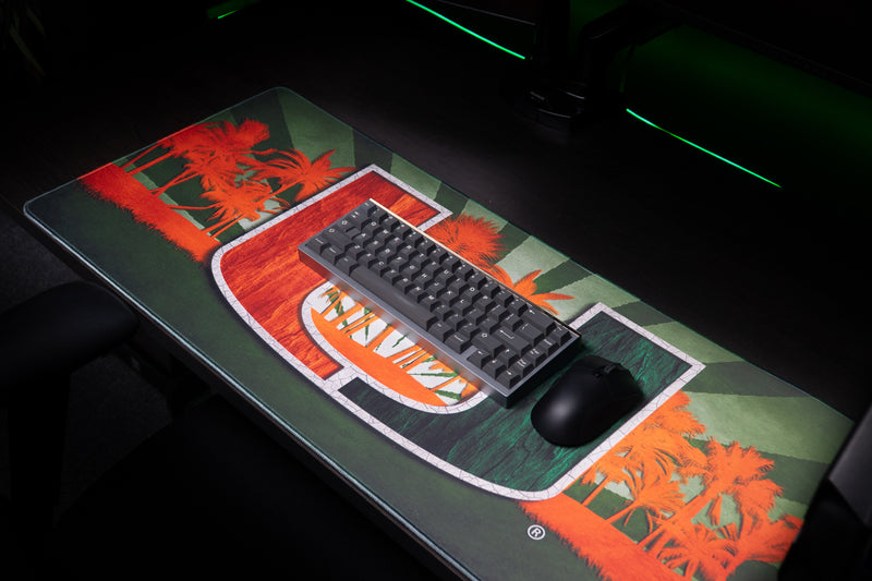 University of Miami Paradise deskmat close angled view with keyboard and mouse on the Paradise deskmat