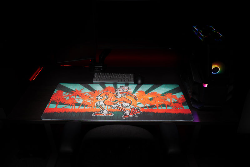 University of Miami Sebastian in Paradise deskmat front view of Sebastian across the tropical palm tree deskmat