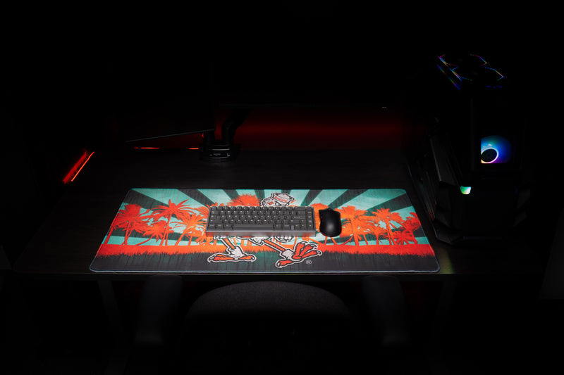 University of Miami Sebastian in Paradise deskmat front view with keyboard and mouse on the Sebastian deskmat