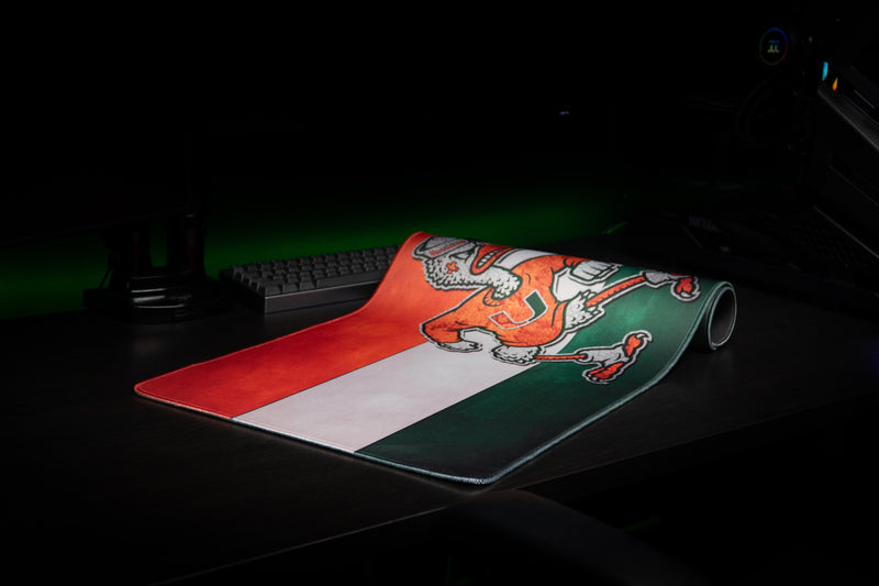 University of Miami Sebastian Pride deskmat partially rolled deskmat showing Sebastian and the striped print