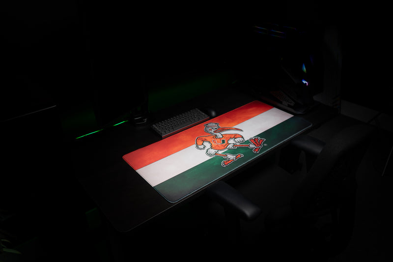 University of Miami Sebastian Pride deskmat wide angled view of the full Sebastian and stripe artwork