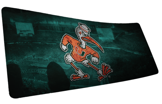 University of Miami Sebastian's Home Turf deskmat mockup of running Sebastian over a teal stadium scene