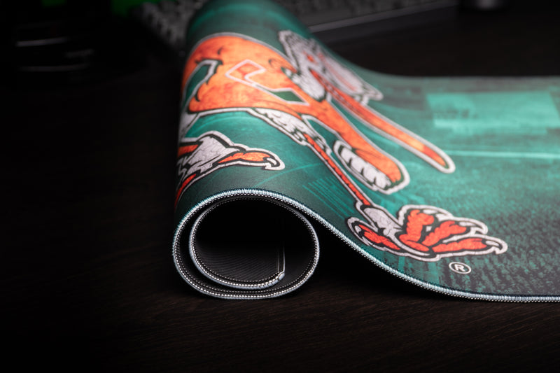 University of Miami Sebastian's Home Turf deskmat close-up of Sebastian artwork and rolled stitched edge