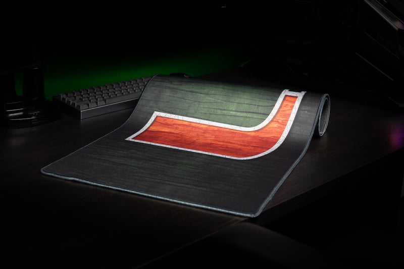 University of Miami The U deskmat partially rolled view showing the orange U and stitched edge