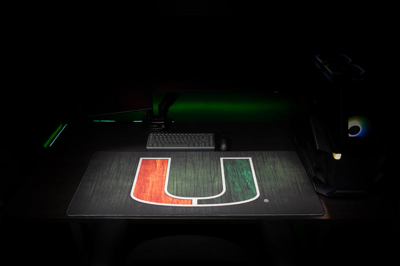 University of Miami The U deskmat front view of the full U deskmat with dark wood-grain texture