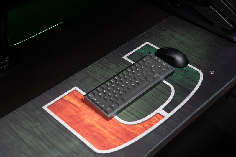 University of Miami The U deskmat angled view with keyboard and mouse on the U deskmat
