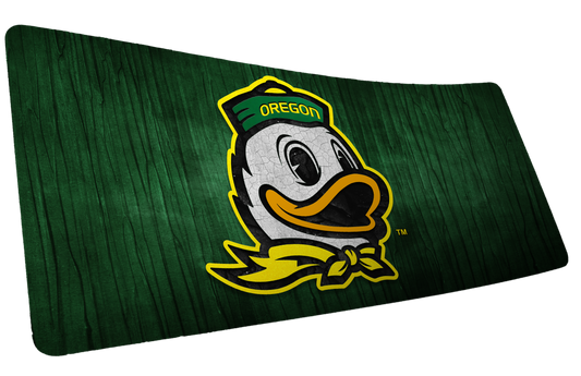 University of Oregon Duck Country deskmat with Oregon duck mascot on a dark green wood-grain background.