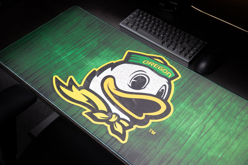 Close-up of the Oregon duck mascot on the Duck Country deskmat.