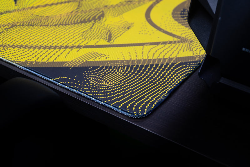 Close-up of the stitched corner and gold pattern on the Oregon Emerald Flight deskmat.