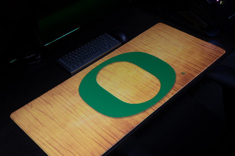 Close-up of the large green O on the Oregon Emerald Grain deskmat.