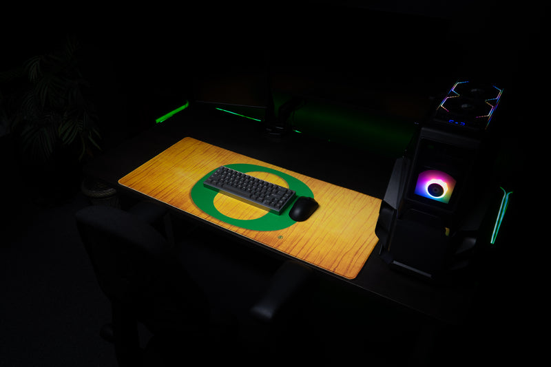 Keyboard and mouse resting on the Oregon Emerald Grain deskmat.