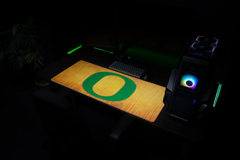 Oregon Emerald Grain deskmat displayed in a dark gaming workstation.
