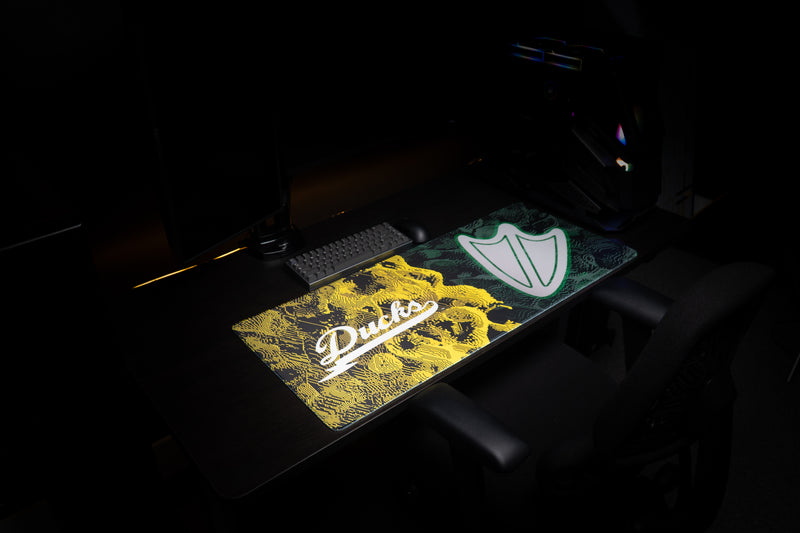 Angled view of the Oregon Emerald Signature deskmat across a gaming desk.
