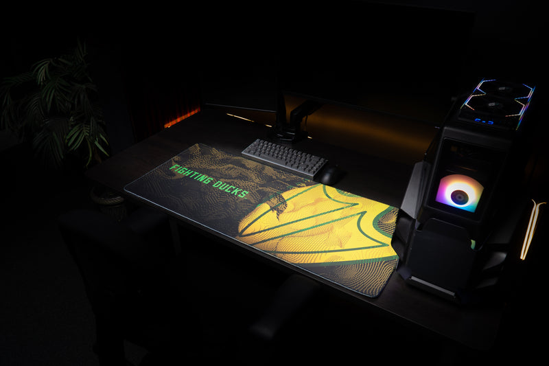 Oregon Fighting Ducks deskmat displayed across a dark gaming workstation.
