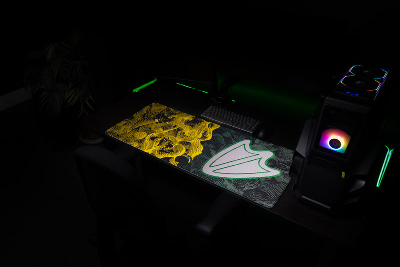 Angled view of the Oregon Flux deskmat in a dark gaming setup.
