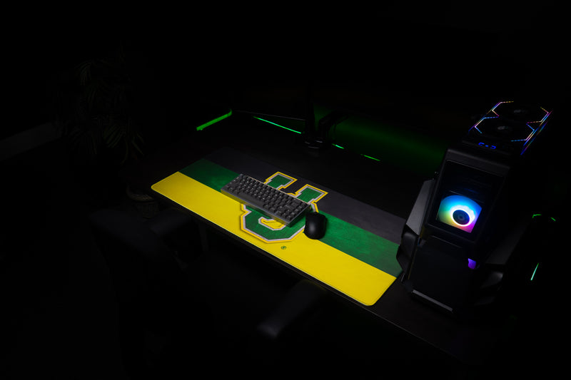 Oregon Pride deskmat with keyboard and mouse in a dark gaming setup.